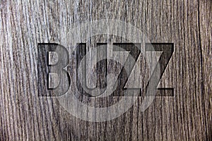 Conceptual hand writing showing Buzz. Business photo showcasing Hum Murmur Drone Fizz Ring Sibilation Whir Alarm Beep Chime Wooden