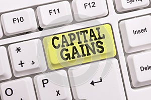 Conceptual hand writing showing Capital Gains. Business photo text Bonds Shares Stocks Profit Income Tax Investment Funds White pc