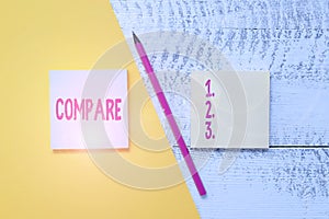 Conceptual hand writing showing Compare. Business photo showcasing Estimate Measure Note the similarities dissimilarities between