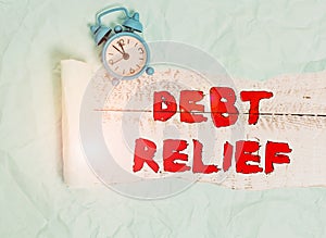 Conceptual hand writing showing Debt Relief. Business photo text a reduction in the amount of debt that a country has to pay Alarm