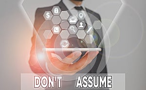 Conceptual hand writing showing Don T Assume. Business photo showcasing do not accept something to be true without question or