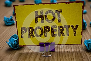 Conceptual hand writing showing Hot Property. Business photo showcasing Something which is sought after or is Heavily Demanded Cli