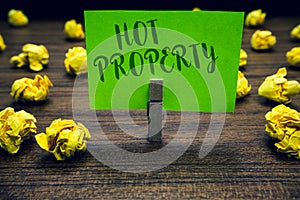 Conceptual hand writing showing Hot Property. Business photo text Something which is sought after or is Heavily Demanded Clothespi