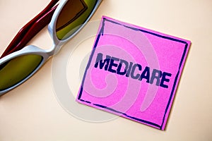 Conceptual hand writing showing Medicare. Business photo text Federal health insurance for people above 65 or with disabilities St