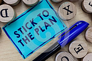 Conceptual hand writing showing Stick To The Plan. Business photo text To adhere to some plan and not deviate from it Follow