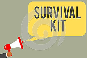 Conceptual hand writing showing Survival Kit. Business photo text Emergency Equipment Collection of items to help someone Man hold