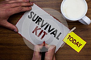 Conceptual hand writing showing Survival Kit. Business photo text Emergency Equipment Collection of items to help someone Man hold