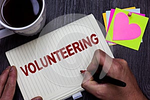 Conceptual hand writing showing Volunteering. Business photo text Provide services for no financial gain Willingly Oblige Man hold