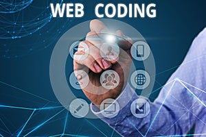 Conceptual hand writing showing Web Coding. Business photo text work involved in developing a web site for the Internet.