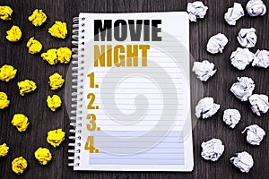 Conceptual hand writing text caption showing Movie Night. Business concept for Wathing Movies Written on notepad note notebook bo