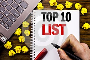 Conceptual hand writing text caption Top 10 Ten List. Business concept for Success ten list Written on tablet laptop, wooden backg