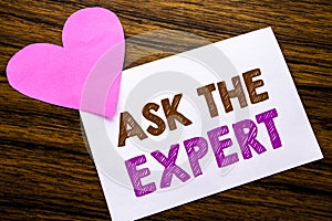Conceptual hand writing text showing Ask The Expert. Concept for Advice Help Question written on sticky note paper, wooden wood ba