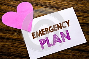 Conceptual hand writing text showing Emergency Plan. Concept for Disaster Protection written on sticky note paper, wooden wood bac