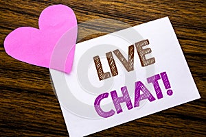 Conceptual hand writing text showing Live Chat . Concept for Communication Livechat written on sticky note paper, wooden wood back photo