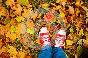 Conceptual hipster style image of legs in boots, trendy gumshoes photo