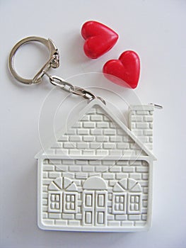 Conceptual house and hearts on white background