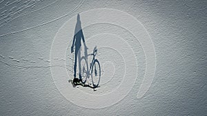 Conceptual image of bicyclist standing near by bike.