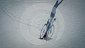 Conceptual image of bicyclist standing near by bike.