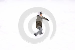 Conceptual image of boy running on the ground covered with snow isolated on white, top view from drone