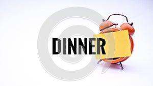 Conceptual image of Business Concept with words Dinner on a clock with a white background. Selective focus.