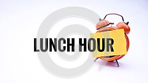 Conceptual image of Business Concept with words Lunch Hour on a clock with a white background. Selective focus.