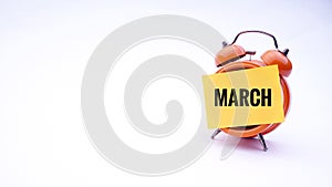 Conceptual image of Business Concept with words March on a clock with a white background. Selective focus.