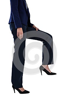 Conceptual image of businesswoman in heels climbing steps