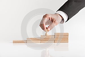 Conceptual image of career management with a businessman placing