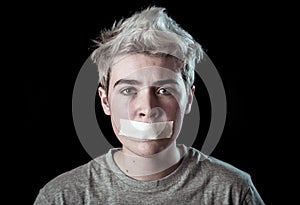Conceptual image of censorship and social tabu. Transgender teenager with mouth sealed