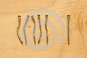 Conceptual image of crooked and straight nails