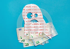 Conceptual image of Euribor as in scary monster floating above Euro money.