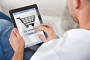 Conceptual image of a man making an online purchase