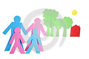 Conceptual image of paper cut out shapes representing a family with trees and house over white background