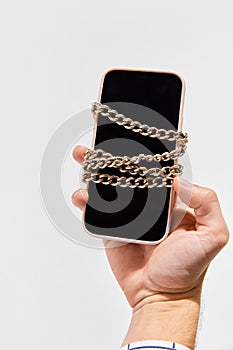 Conceptual image of phone with chain symbolizing blockchain system. Storage and distribution of information