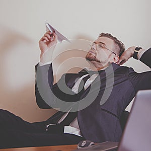 Conceptual image: professional burnout, laziness, unwillingness to work. Close up portrait of slacker businessman sitting in photo