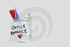 Conceptual image of sticky notepaper with heart shape depicting office romance