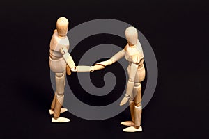 Conceptual image of two manikins shaking hands