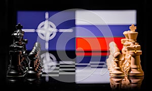 Conceptual image of war between Russia and NATO using chess pieces and national flags