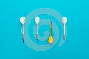 Conceptual image of yellow dart pointing to other direction on blue background