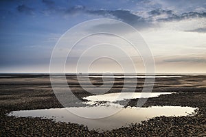 Conceptual landscape image of two people on remote beach