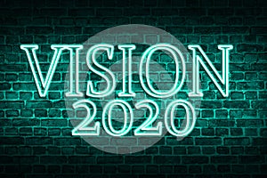 A conceptual message written by the neon light on the wall shows `vision 2020`. Business motivation, inspiration concepts ideas. photo