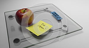Conceptual and modern still life delicious apple and yellow posit note text saying eat clean stuck on bathroom scale in weight