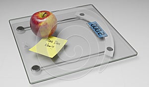 Conceptual and modern still life delicious apple and yellow posit note text saying start diet now stuck on bathroom scale in photo