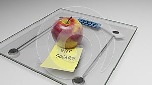 Conceptual and modern still life delicious apple and yellow posit note text saying stop sugar stuck on bathroom scale in weight photo