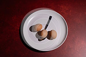 Conceptual photo of 3 eggs and spoon