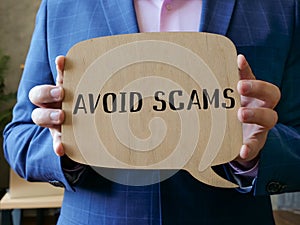 Conceptual photo about AVOID SCAMS with written phrase