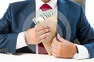 Conceptual photo of bribed man putting money in the suit pocket