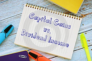 Conceptual photo about Capital Gains vs. Dividend Income with handwritten phrase