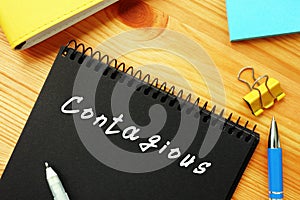 Conceptual photo about Contagious  with handwritten text