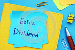 Conceptual photo about Extra Dividend with handwritten text